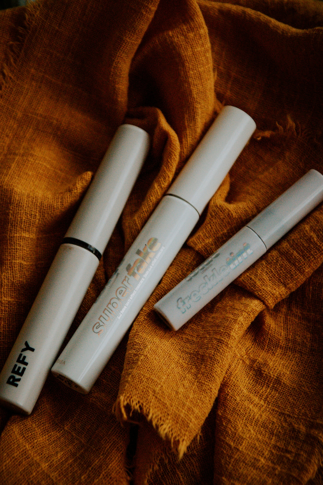 a few white pens on a brown blanket