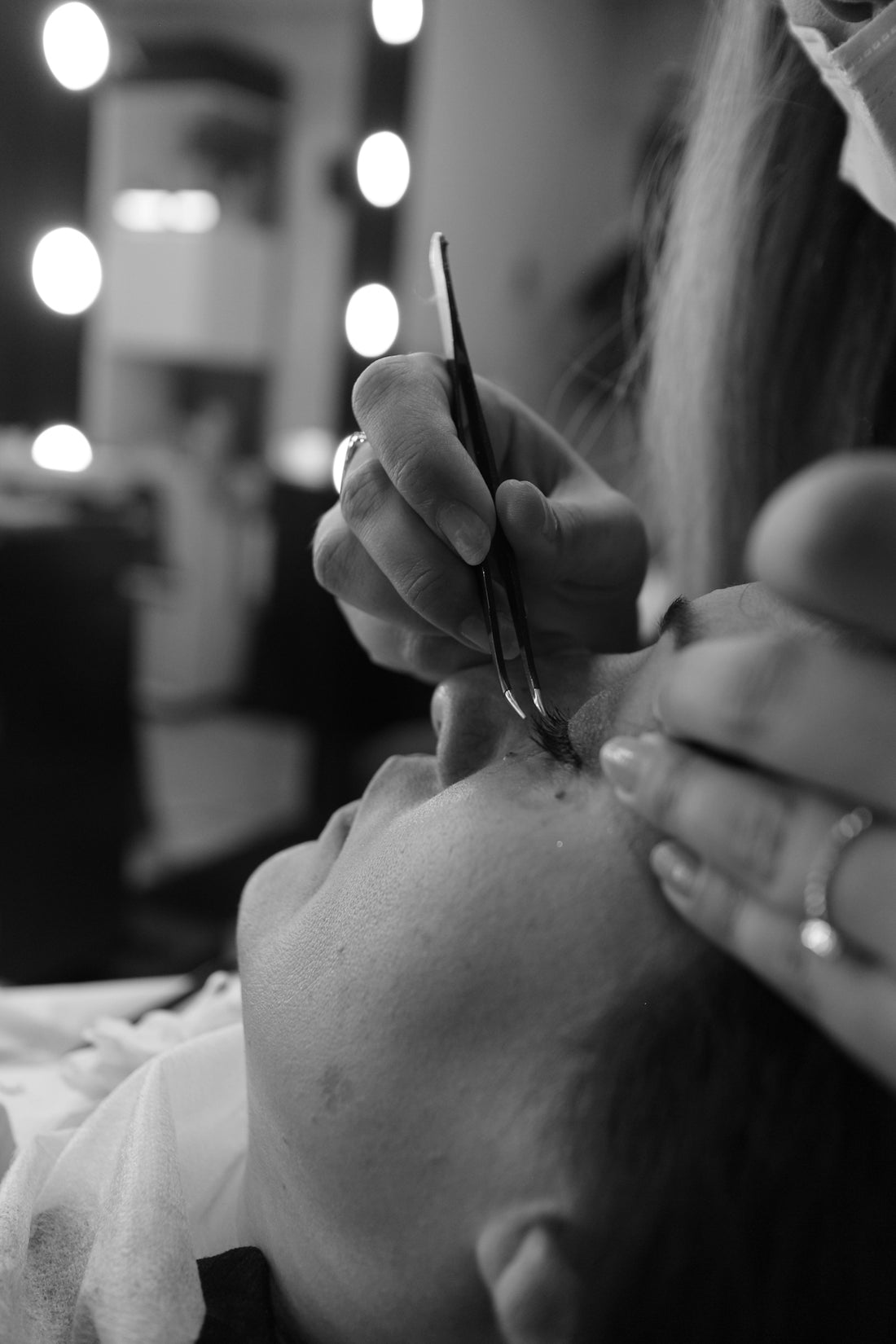 A woman getting her hair cut by a hair stylist